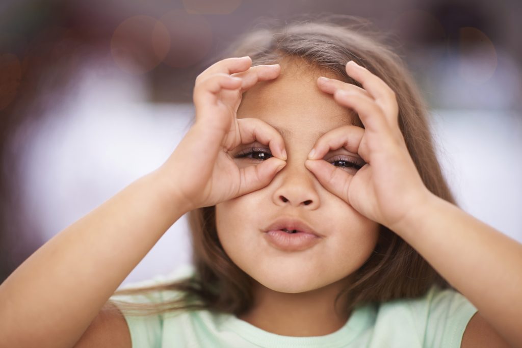 Shot of a playful little girl with pulling a funny face